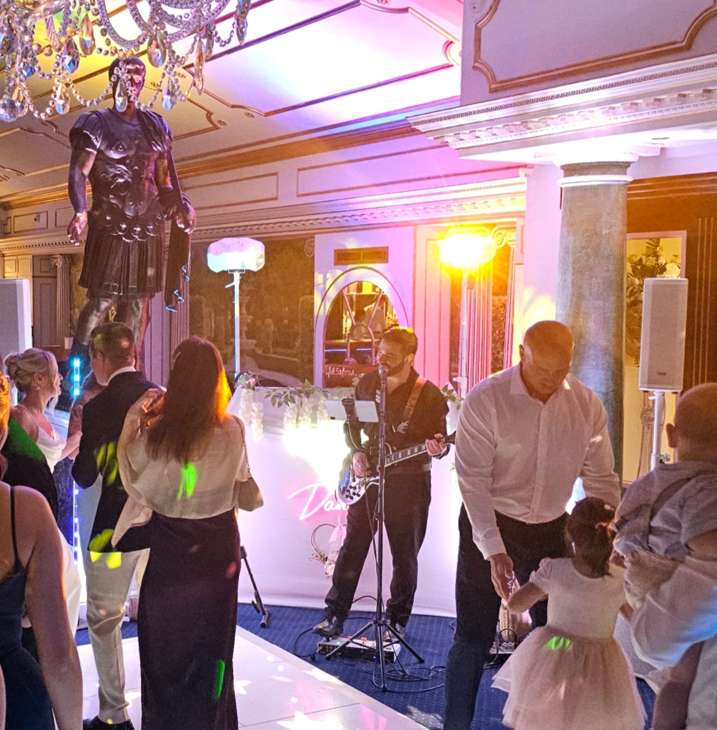Live guitarist and singer performing at an elegant indoor celebration